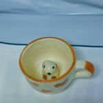 Novelty Ceramic Coffee Mug with Hidden Dog Design, Orange Heart Pattern, White